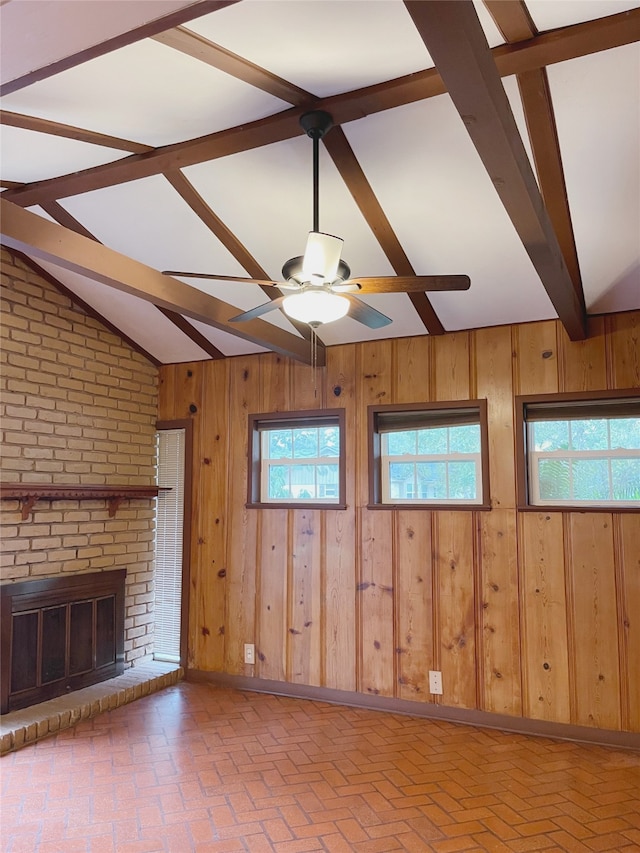 10214 Moorberry Ln, Houston, TX 77043 - unfurnished living room with ceiling fan, wooden walls, a brick fireplace, and brick patterned floors
