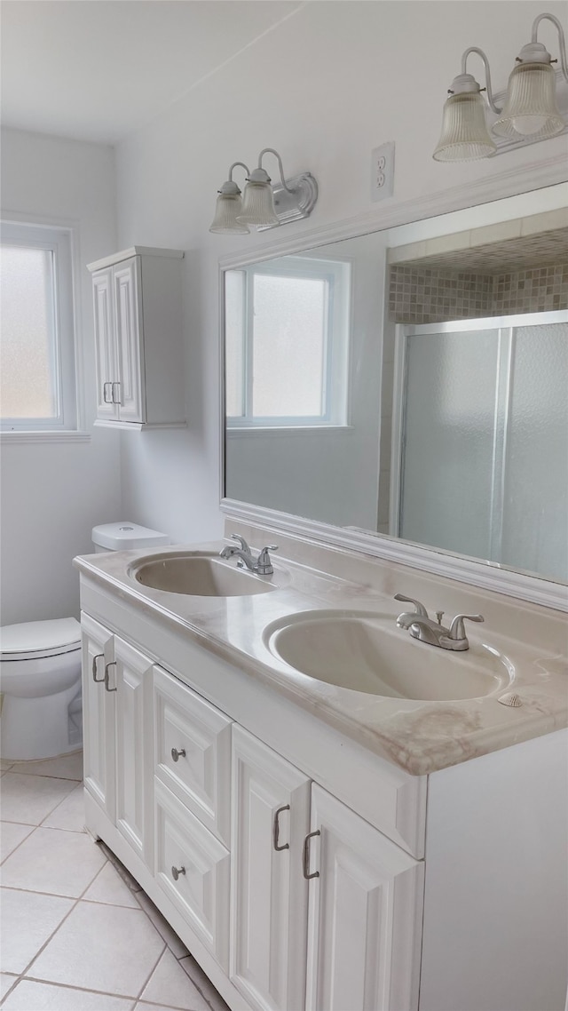 10214 Moorberry Ln, Houston, TX 77043 - bathroom with double vanity, a stall shower, tile patterned flooring, toilet, and plenty of natural light