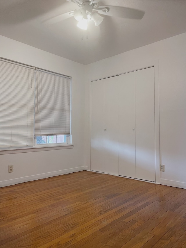 10214 Moorberry Ln, Houston, TX 77043 - unfurnished bedroom featuring wood-type flooring, a closet, baseboards, and a ceiling fan