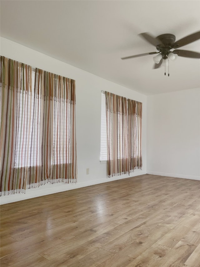 10214 Moorberry Ln, Houston, TX 77043 - unfurnished room with a ceiling fan, light wood-style floors, and baseboards