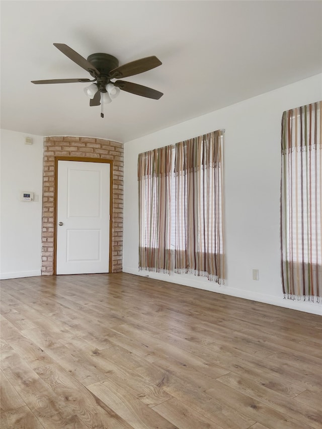 10214 Moorberry Ln, Houston, TX 77043 - unfurnished room with a ceiling fan, light wood-style flooring, and baseboards