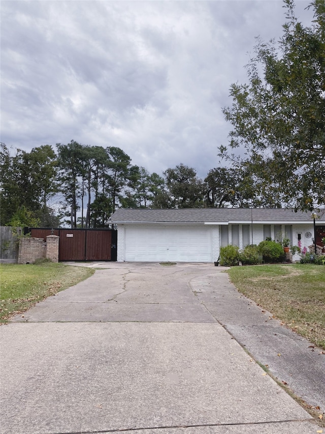 10214 Moorberry Ln, Houston, TX 77043 - view of front of house with concrete driveway, a garage, and brick siding