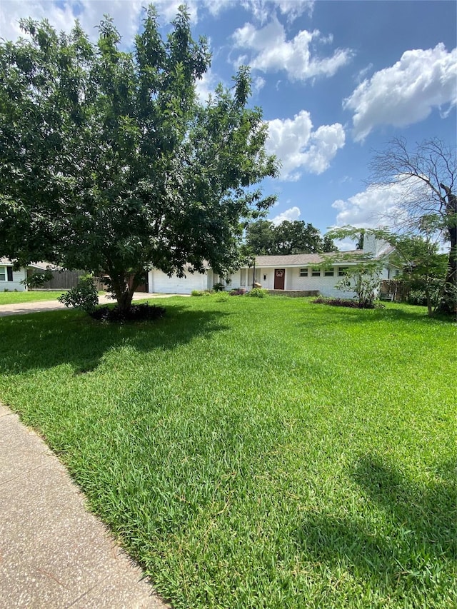 10214 Moorberry Ln, Houston, TX 77043 - view of green lawn with an attached garage