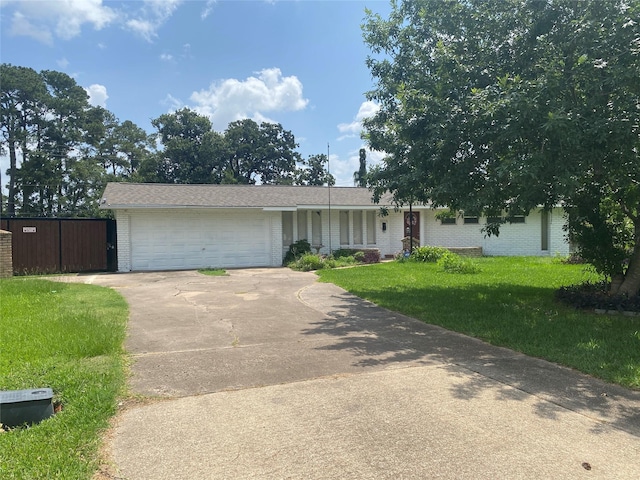 10214 Moorberry Ln, Houston, TX 77043 - view of front facade featuring brick siding, a front lawn, concrete driveway, and a garage