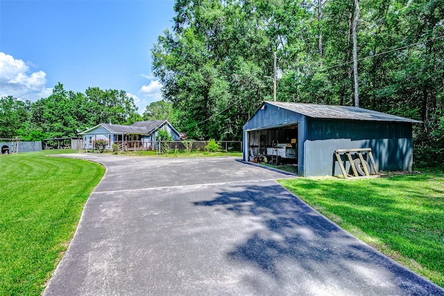 637 County Road 6502 E, Dayton, TX 77535 - view of front of house with a garage, an outbuilding, and a pole building