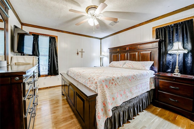 637 County Road 6502 E, Dayton, TX 77535 - bedroom featuring crown molding, light wood finished floors, a textured ceiling, baseboards, and ceiling fan