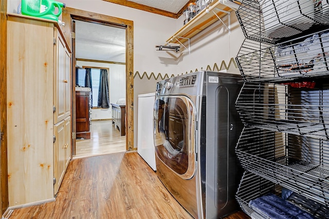 637 County Road 6502 E, Dayton, TX 77535 - washroom featuring wood finished floors, ornamental molding, and washing machine and clothes dryer