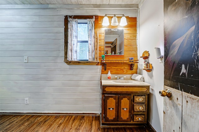 637 County Road 6502 E, Dayton, TX 77535 - bathroom with vanity, wood finished floors, baseboards, and wooden walls