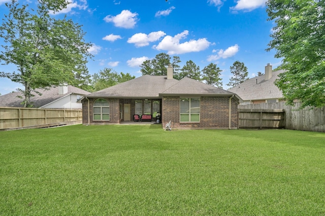 3909 Aspen Dr, Montgomery, TX 77356 - back of house with brick siding, a chimney, a patio area, and a shingled roof