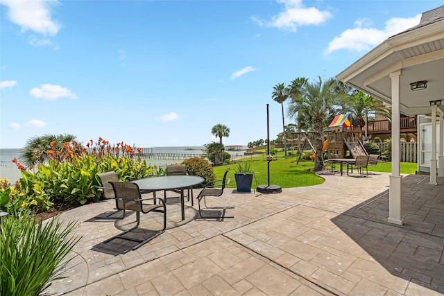 5123 W Bayshore Dr, Bacliff, TX 77518 - view of patio / terrace featuring a playground, a water view, and outdoor dining area
