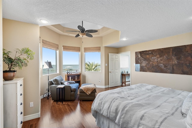 5123 W Bayshore Dr, Bacliff, TX 77518 - bedroom with a textured ceiling, baseboards, hardwood / wood-style flooring, a raised ceiling, and a ceiling fan
