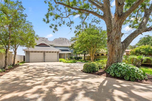 5123 W Bayshore Dr, Bacliff, TX 77518 - view of front of home with an attached garage, concrete driveway, and roof with shingles