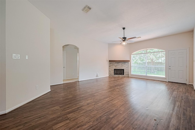 2311 Foster Leaf Ct, Richmond, TX 77406 - unfurnished living room featuring a ceiling fan, arched walkways, dark wood-style flooring, and a fireplace
