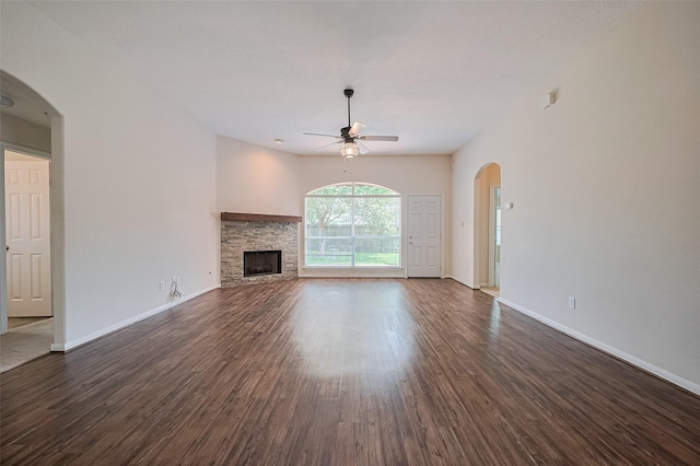 2311 Foster Leaf Ct, Richmond, TX 77406 - unfurnished living room with ceiling fan, dark wood-style floors, arched walkways, and a fireplace