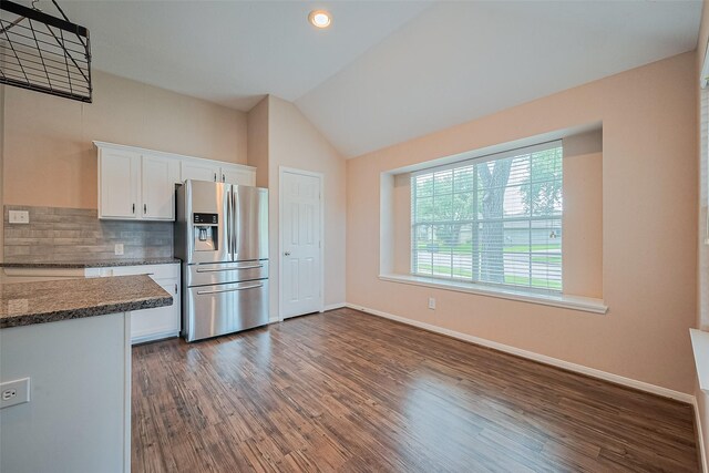 2311 Foster Leaf Ct, Richmond, TX 77406 - kitchen featuring stainless steel fridge, white cabinetry, lofted ceiling, tasteful backsplash, and dark wood finished floors