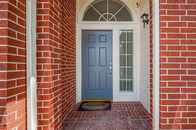 2311 Foster Leaf Ct, Richmond, TX 77406 - view of exterior entry featuring brick siding and a surveillance system
