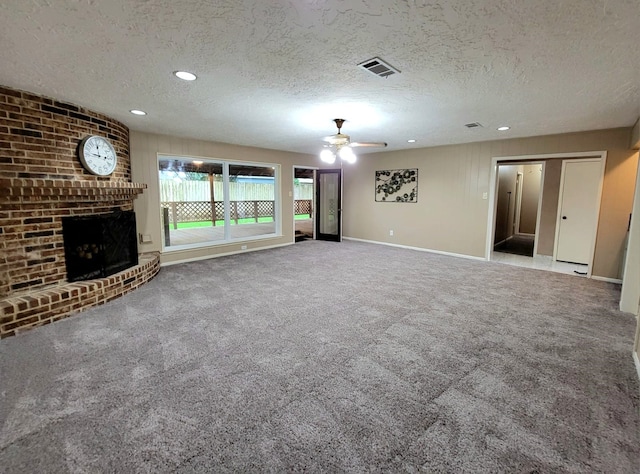 3135 Apple Dr, Missouri City, TX 77459 - unfurnished living room featuring ceiling fan, a textured ceiling, carpet floors, a fireplace, and recessed lighting