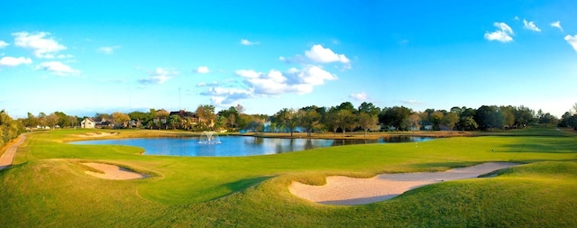 3135 Apple Dr, Missouri City, TX 77459 - view of property's community with a water view, view of golf course, view of wooded area, and a lawn