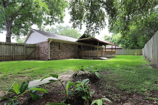 3135 Apple Dr, Missouri City, TX 77459 - back of property featuring a fenced backyard, brick siding, and a wooden deck