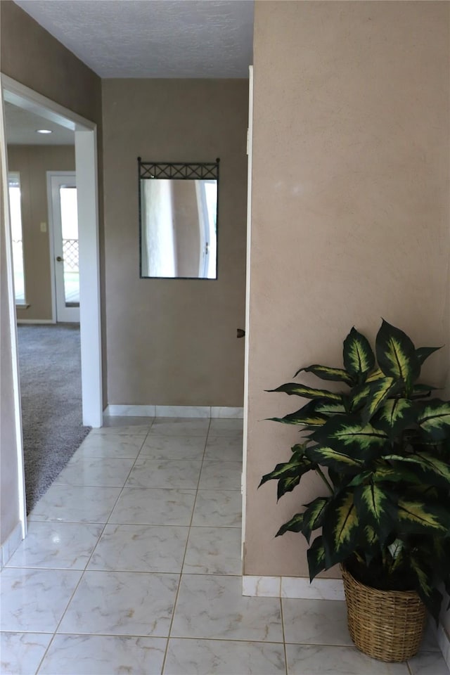 3135 Apple Dr, Missouri City, TX 77459 - corridor featuring light marble finish flooring and baseboards
