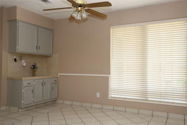 3135 Apple Dr, Missouri City, TX 77459 - unfurnished dining area with a ceiling fan and light tile patterned floors
