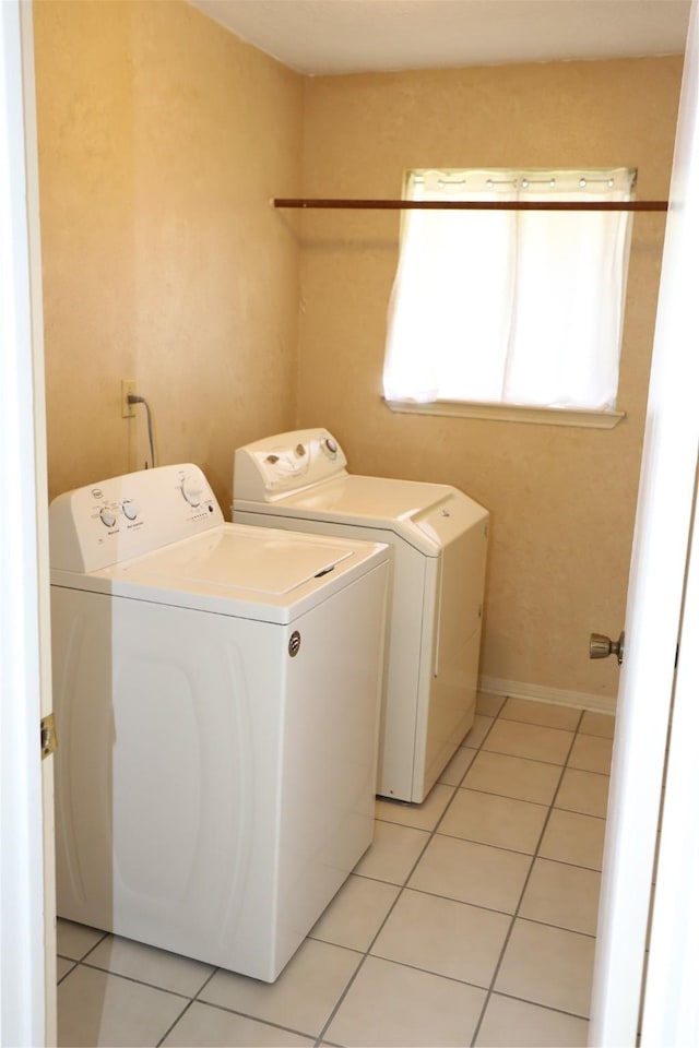 3135 Apple Dr, Missouri City, TX 77459 - laundry room with washing machine and clothes dryer and light tile patterned flooring