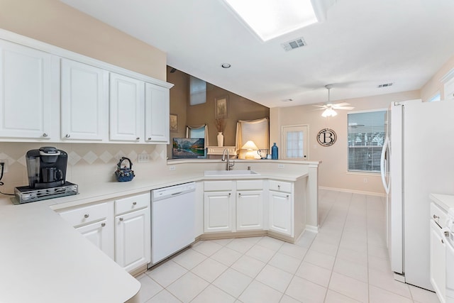 17131 Valley Palms Dr, Spring, TX 77379 - kitchen with white appliances, a peninsula, light countertops, and white cabinets