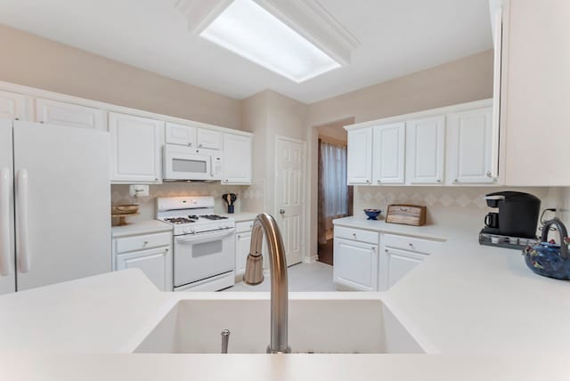 17131 Valley Palms Dr, Spring, TX 77379 - kitchen featuring white appliances, white cabinets, decorative backsplash, and light countertops