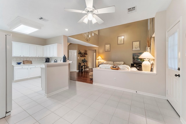 17131 Valley Palms Dr, Spring, TX 77379 - kitchen featuring open floor plan, light countertops, white cabinets, freestanding refrigerator, and tasteful backsplash