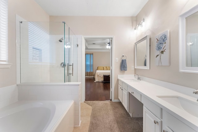 17131 Valley Palms Dr, Spring, TX 77379 - bathroom featuring double vanity, a garden tub, ensuite bathroom, a stall shower, and ceiling fan