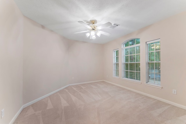 17131 Valley Palms Dr, Spring, TX 77379 - empty room featuring light carpet, a ceiling fan, and a textured ceiling