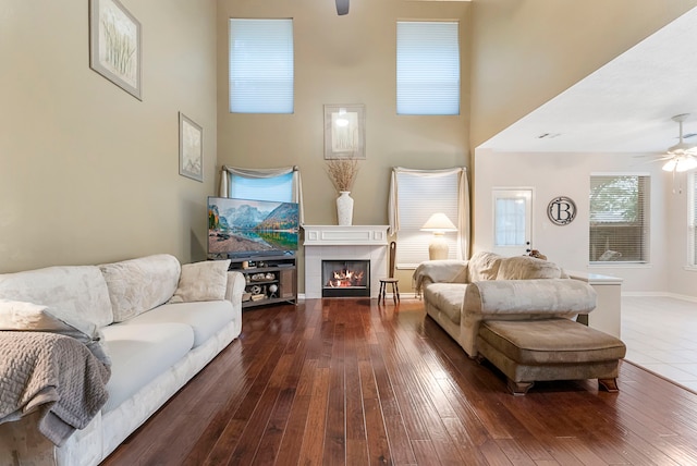 17131 Valley Palms Dr, Spring, TX 77379 - living area featuring ceiling fan, dark wood-type flooring, a fireplace, and a towering ceiling