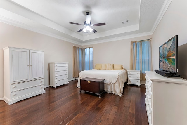 17131 Valley Palms Dr, Spring, TX 77379 - bedroom featuring a tray ceiling, dark wood-type flooring, ceiling fan, and crown molding