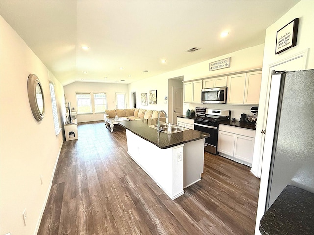 24446 Elmwood Falls Dr, Spring, TX 77373 - kitchen featuring range with gas cooktop, stainless steel microwave, a sink, dark wood finished floors, and dark countertops