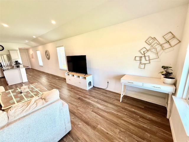 24446 Elmwood Falls Dr, Spring, TX 77373 - living area with dark wood-style flooring, lofted ceiling, and baseboards