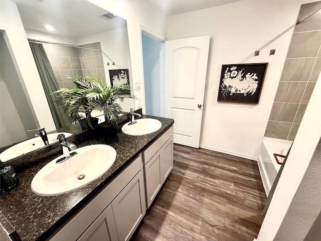 24446 Elmwood Falls Dr, Spring, TX 77373 - full bath featuring double vanity, wood finished floors, and baseboards
