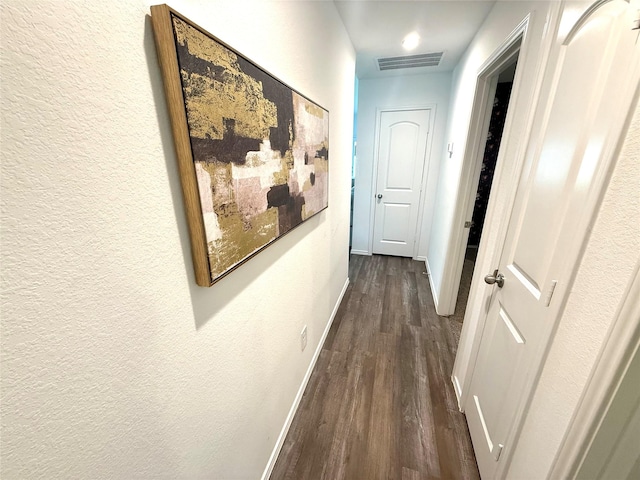 24446 Elmwood Falls Dr, Spring, TX 77373 - hallway with dark wood-type flooring, baseboards, and a textured wall