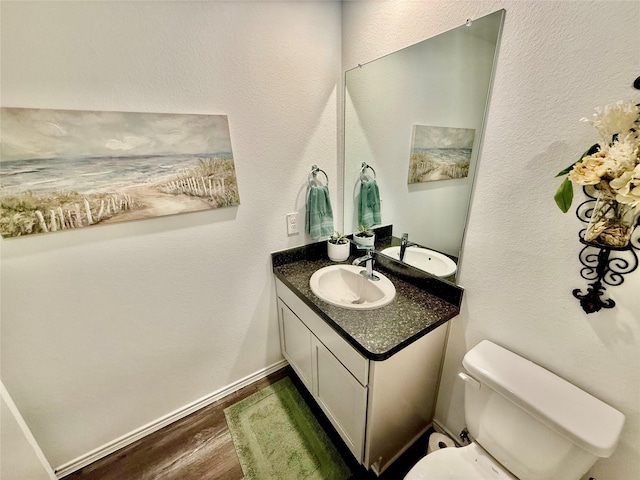 24446 Elmwood Falls Dr, Spring, TX 77373 - bathroom featuring vanity, wood finished floors, toilet, and baseboards
