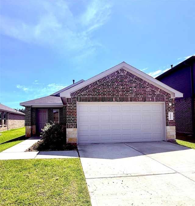 24446 Elmwood Falls Dr, Spring, TX 77373 - ranch-style house featuring brick siding, a garage, driveway, and stone siding