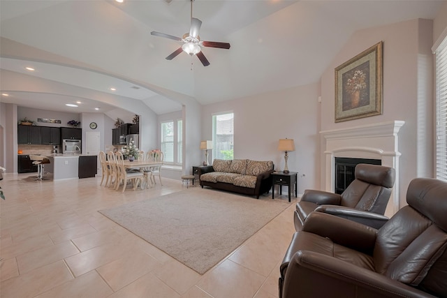 8107 Bosphorus St, Houston, TX 77044 - living area with vaulted ceiling, ceiling fan, a glass covered fireplace, recessed lighting, and light tile patterned floors