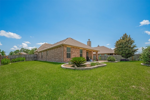 8107 Bosphorus St, Houston, TX 77044 - rear view of house featuring brick siding, a chimney, and a patio