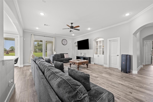 1420 Palomino Trl, Angleton, TX 77515 - living area with arched walkways, baseboards, ornamental molding, light wood-type flooring, and recessed lighting