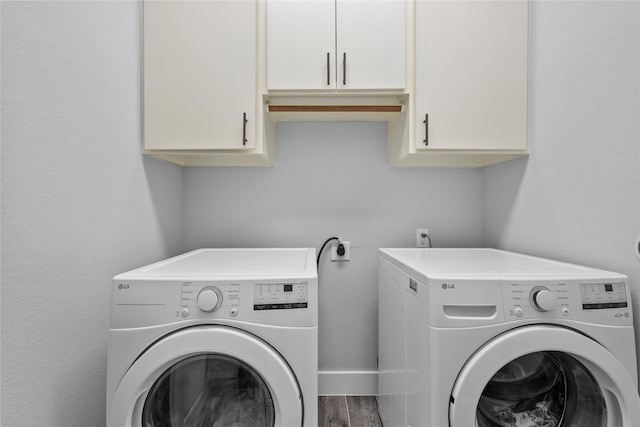 1420 Palomino Trl, Angleton, TX 77515 - laundry room featuring washer and dryer, cabinet space, and wood finished floors