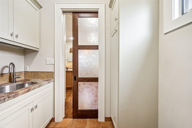5311 Indigo St, Houston, TX 77096 - kitchen with stone counters, light tile patterned flooring, and white cabinets