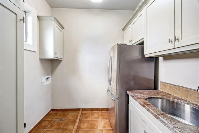 5311 Indigo St, Houston, TX 77096 - kitchen with freestanding refrigerator, stone countertops, and white cabinets