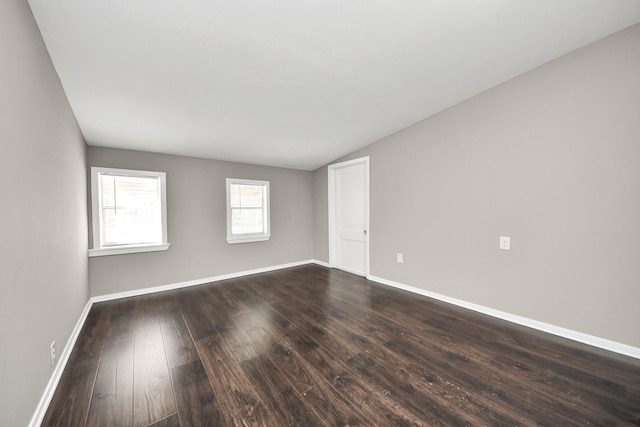 5130 Enyart St, Houston, TX 77021 - spare room with dark wood-type flooring, lofted ceiling, and baseboards