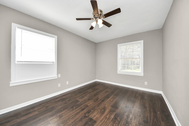5130 Enyart St, Houston, TX 77021 - unfurnished room with dark wood finished floors, baseboards, and a ceiling fan