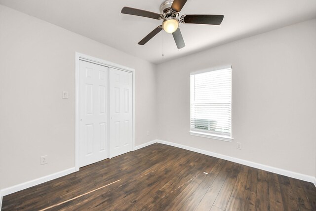 3437 Seabrook St, Houston, TX 77021 - unfurnished bedroom with baseboards, dark wood finished floors, a closet, and a ceiling fan