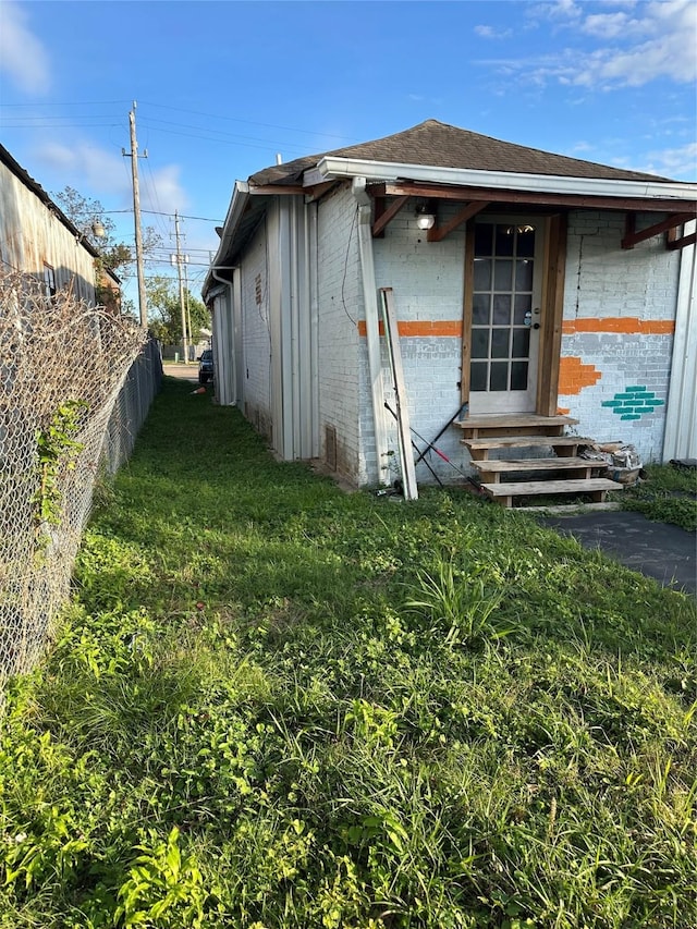 304 Lockwood Dr, Houston, TX 77011 - view of side of property featuring entry steps and roof with shingles