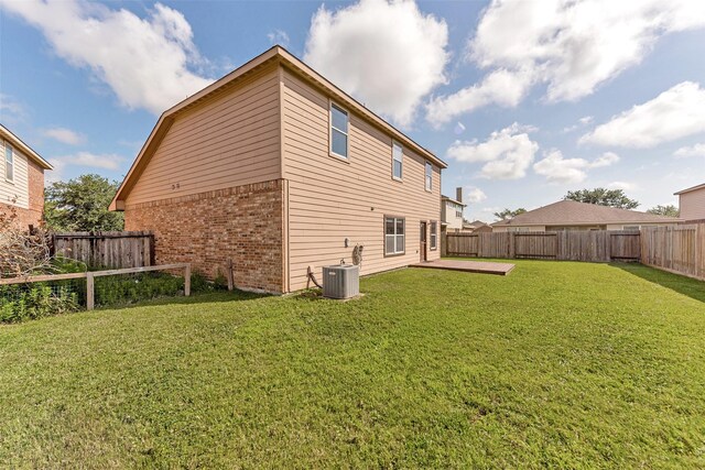 9807 Opal Rock Dr, Rosharon, TX 77583 - rear view of house with brick siding and central AC